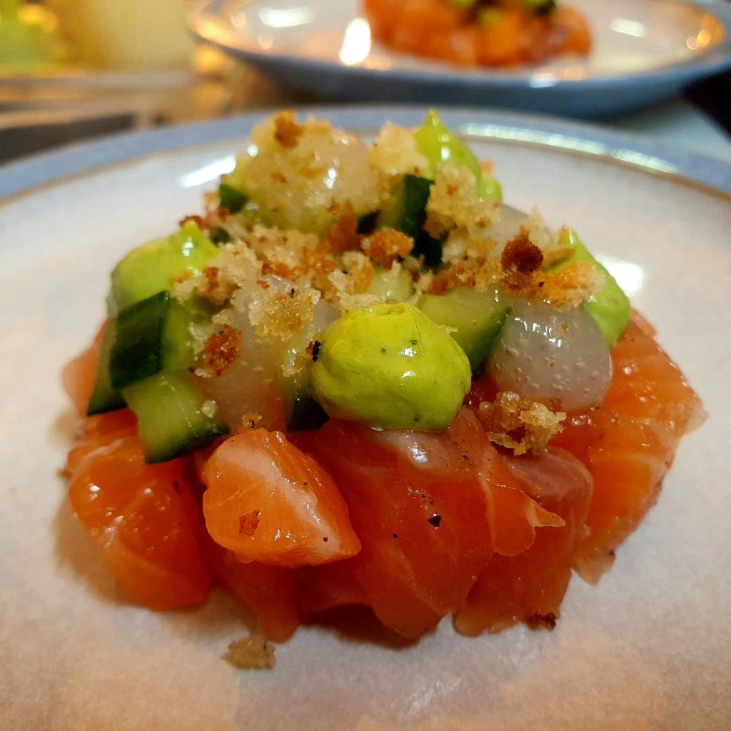 a white plate topped with fruit and a scoop of ice cream